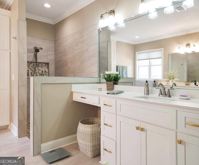 bathroom featuring ornamental molding and vanity