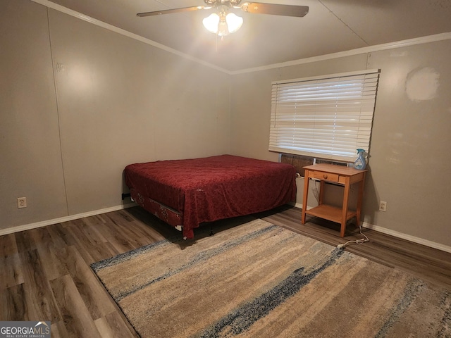 bedroom featuring ornamental molding, dark wood-type flooring, ceiling fan, and baseboards