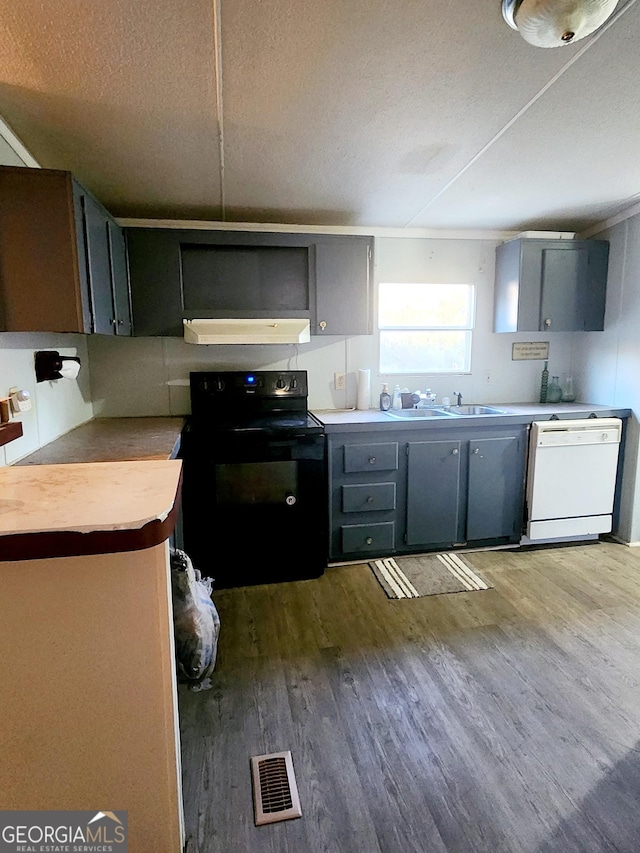 kitchen with visible vents, light countertops, electric range, dishwasher, and under cabinet range hood