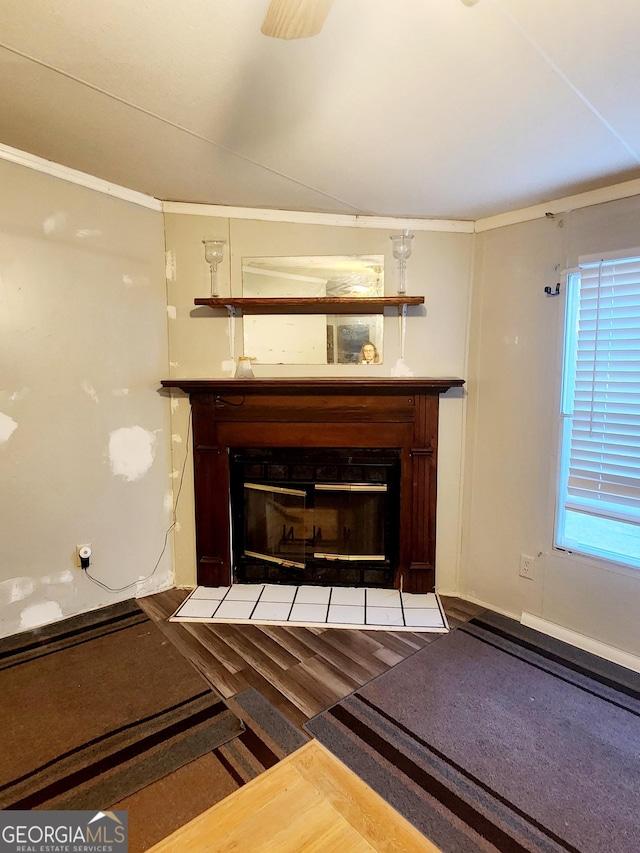 interior details featuring a fireplace with flush hearth and wood finished floors