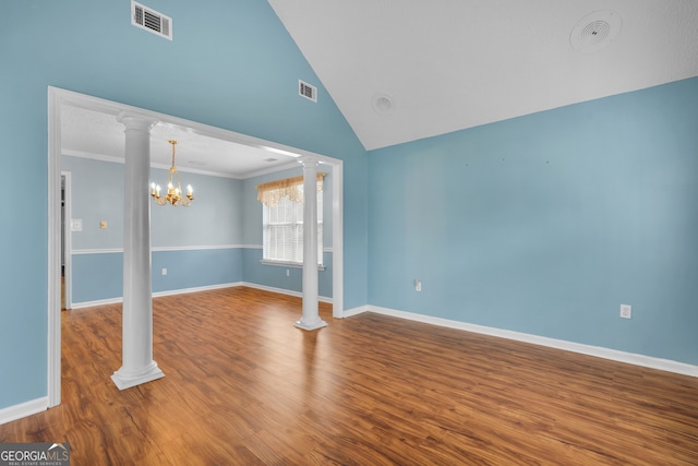 unfurnished room with ornate columns, crown molding, hardwood / wood-style flooring, and a notable chandelier