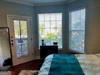 bedroom with ornamental molding and fridge