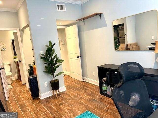 home office featuring ornamental molding and dark hardwood / wood-style floors