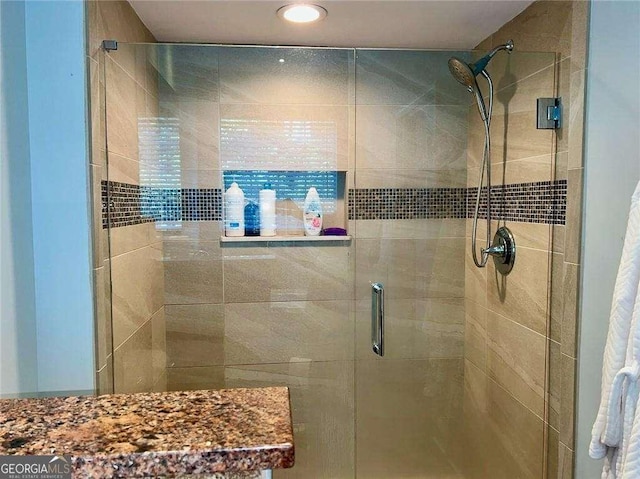 bathroom with a shower with shower door