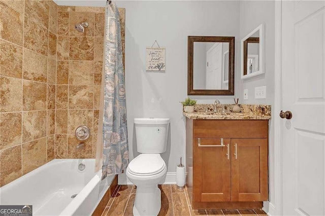 full bathroom featuring vanity, shower / bath combo, and toilet