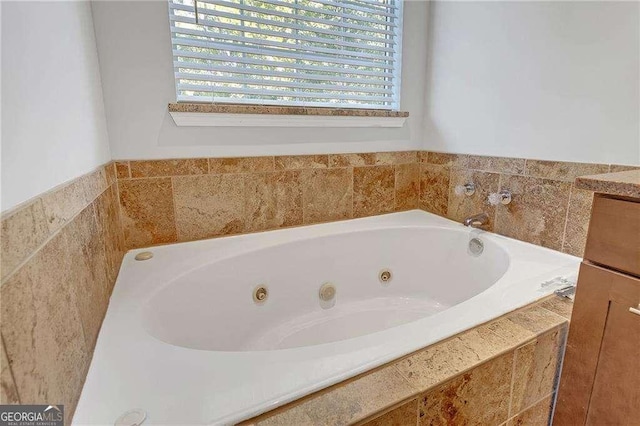 bathroom featuring tiled tub