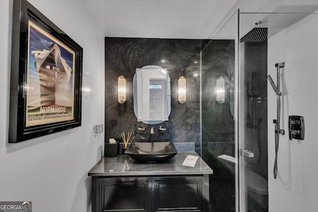 bathroom with vanity, toilet, and walk in shower