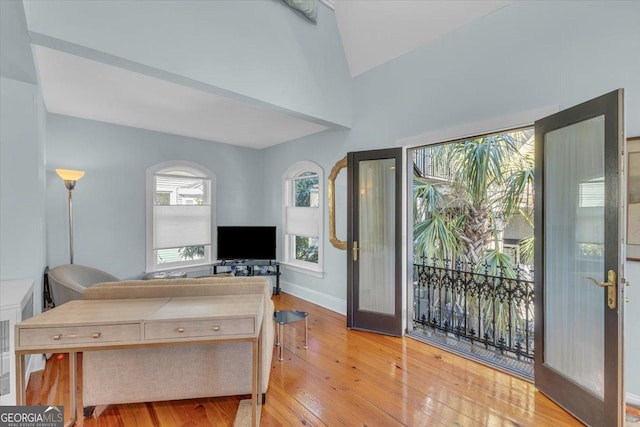 living room featuring light hardwood / wood-style flooring and french doors