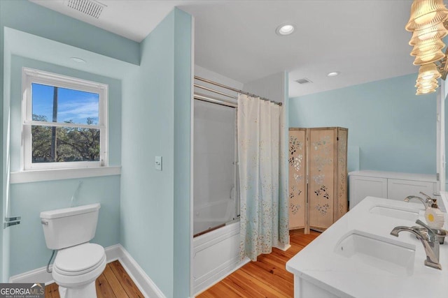 full bathroom with toilet, vanity, shower / bathtub combination with curtain, and hardwood / wood-style flooring