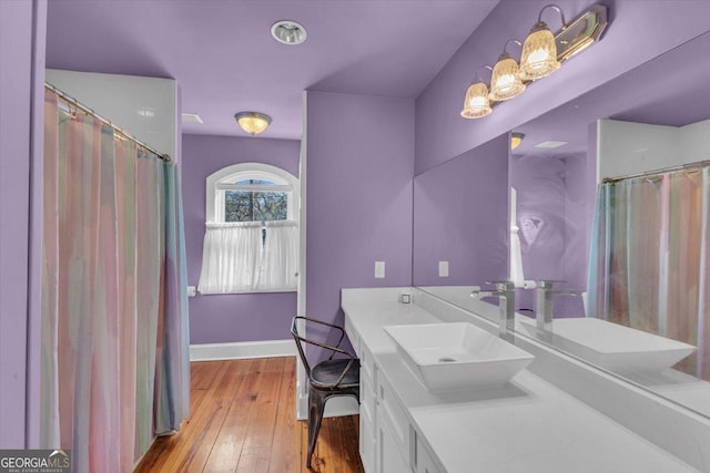 bathroom featuring vanity and hardwood / wood-style floors