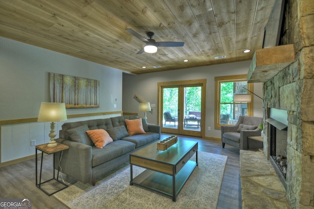 living room featuring hardwood / wood-style flooring, a fireplace, wooden ceiling, and ceiling fan