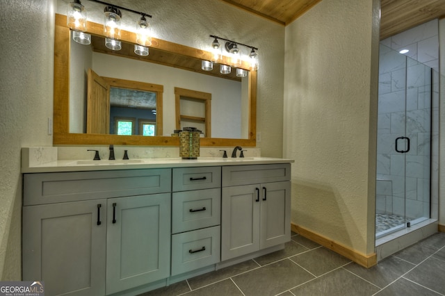 bathroom featuring vanity, an enclosed shower, and tile patterned floors