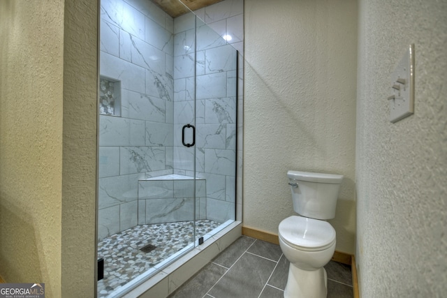 bathroom with an enclosed shower, tile patterned flooring, and toilet