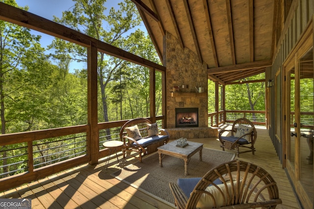 unfurnished sunroom featuring vaulted ceiling and a fireplace