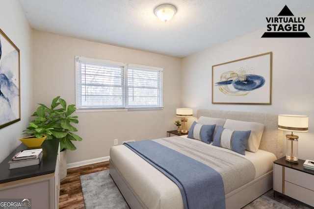 bedroom with dark hardwood / wood-style floors