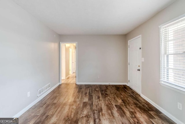 unfurnished room with dark hardwood / wood-style floors