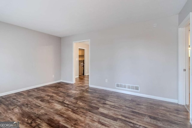 spare room featuring dark hardwood / wood-style flooring