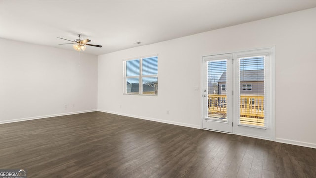 empty room with dark hardwood / wood-style floors and ceiling fan