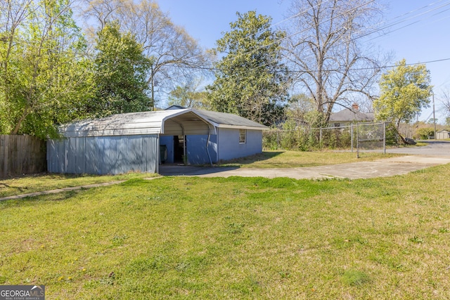 view of yard with a carport and fence