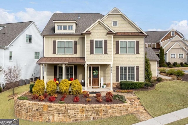 craftsman-style house with central AC unit, covered porch, and a front lawn