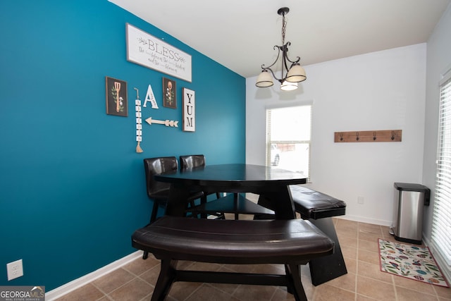 dining room with a notable chandelier and light tile patterned flooring