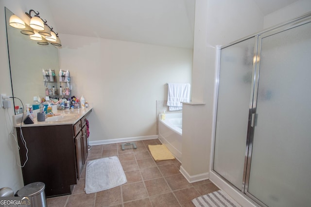 bathroom with tile patterned flooring, shower with separate bathtub, and vanity