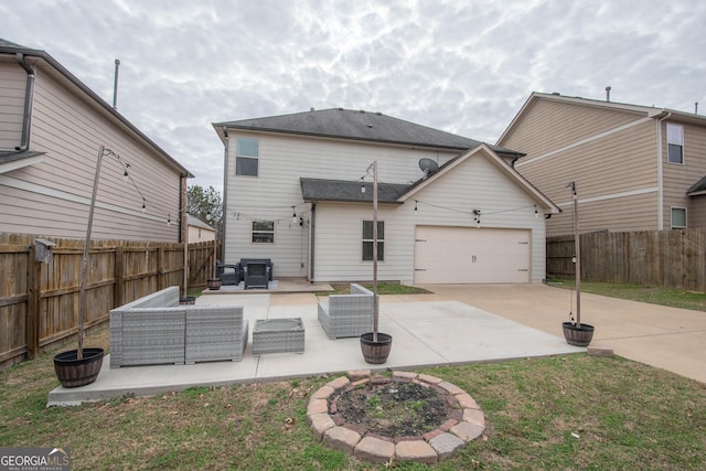 rear view of house with a garage, a yard, outdoor lounge area, and a patio