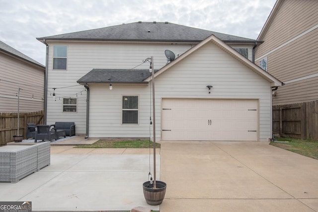 rear view of property featuring a garage