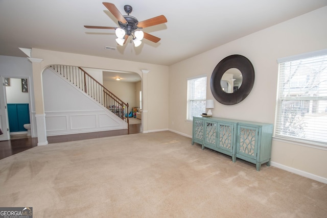 unfurnished living room with ceiling fan and light colored carpet