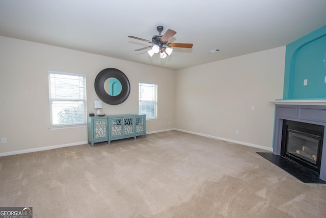 unfurnished living room with ceiling fan and light colored carpet