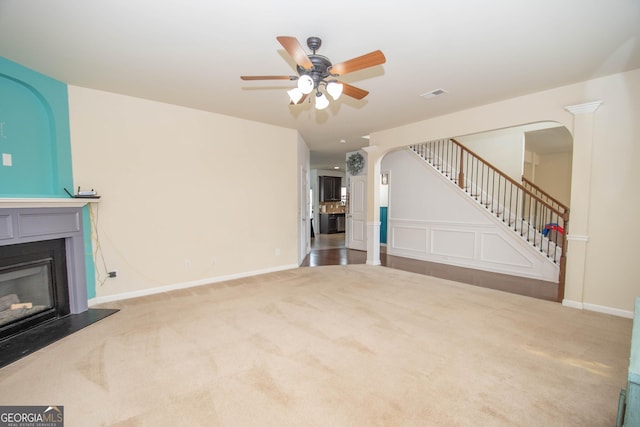 unfurnished living room with carpet floors and ceiling fan