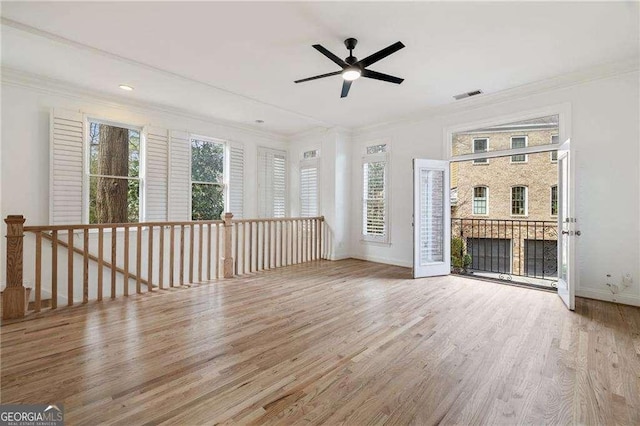 unfurnished living room featuring ornamental molding, a fireplace, and light hardwood / wood-style floors