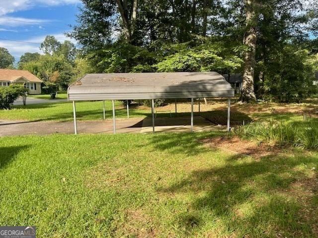 surrounding community with a carport and a yard