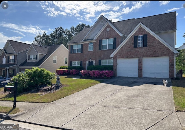 view of front of property featuring a garage and a front yard