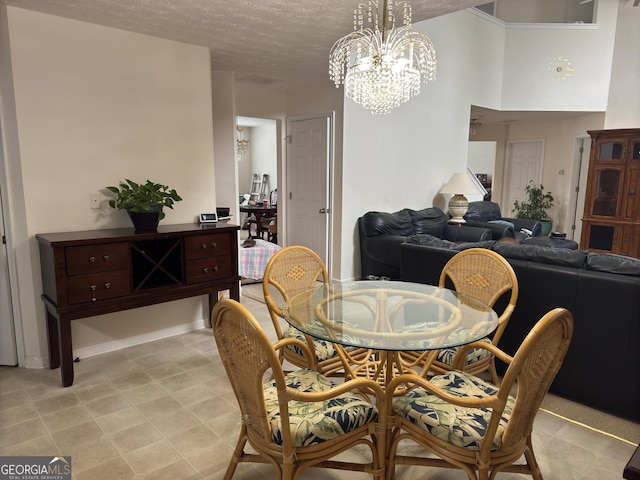 dining room with a textured ceiling and a notable chandelier