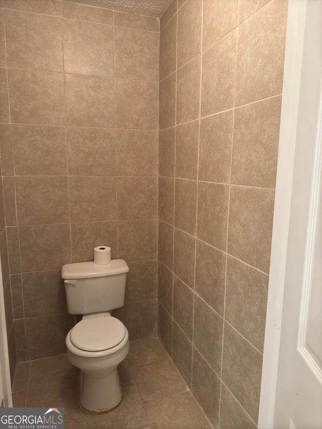 bathroom with tile patterned flooring and toilet