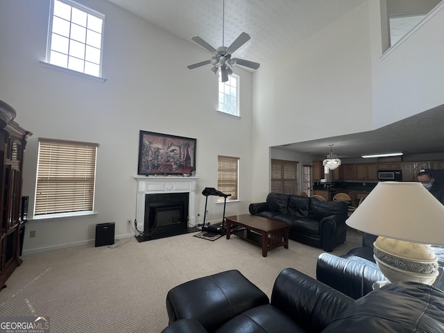 living room with ceiling fan and light colored carpet