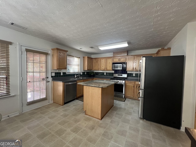 kitchen with sink, stainless steel appliances, and a center island