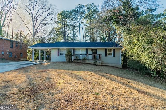 ranch-style home with a front yard, a carport, and a porch