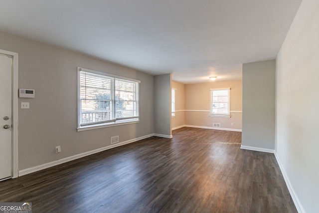 spare room featuring dark hardwood / wood-style floors