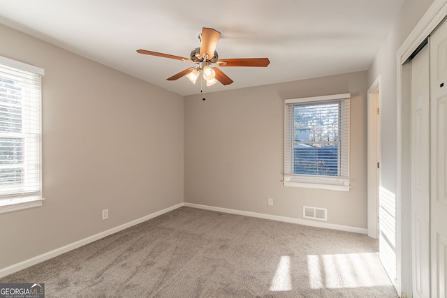 carpeted empty room with ceiling fan