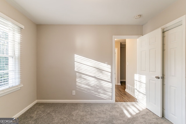 unfurnished room featuring carpet