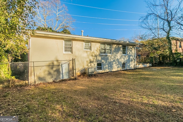 rear view of house with a yard