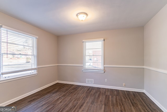 spare room with dark hardwood / wood-style floors