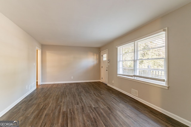 unfurnished room featuring dark hardwood / wood-style flooring