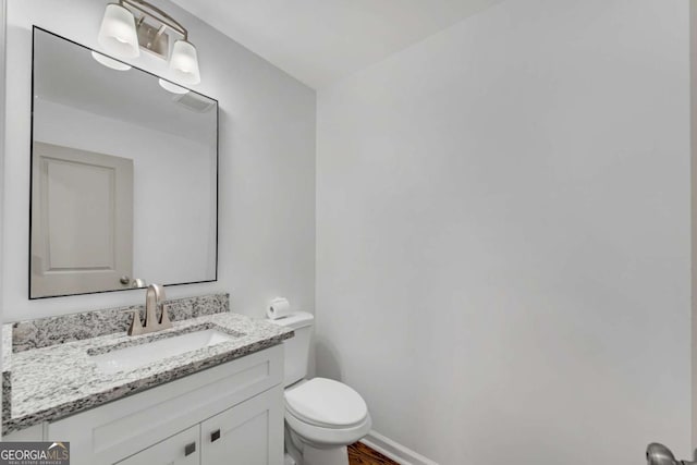 bathroom with vanity and toilet