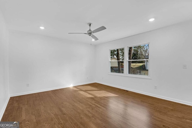 spare room featuring hardwood / wood-style flooring and ceiling fan