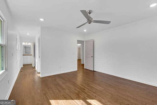 empty room featuring dark hardwood / wood-style flooring and ceiling fan