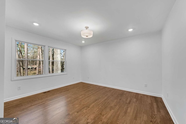 empty room with dark wood-type flooring