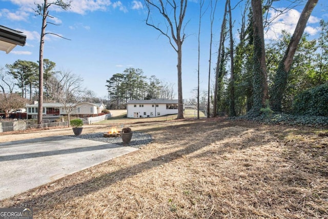 view of yard with an outdoor fire pit